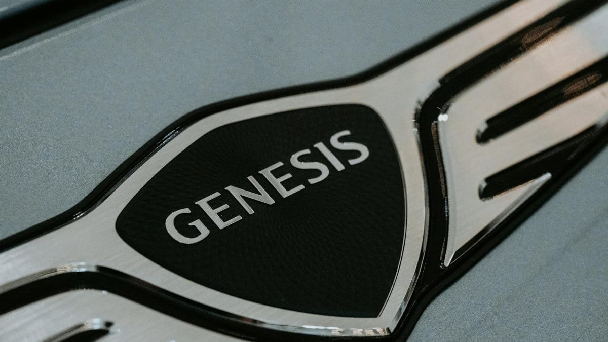 Detailed close-up of the Genesis car logo emblem for automotive branding.