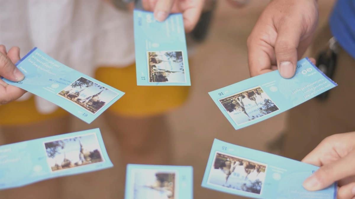 Close-up of a group holding tourist attraction tickets. Perfect for travel and tourism themes.