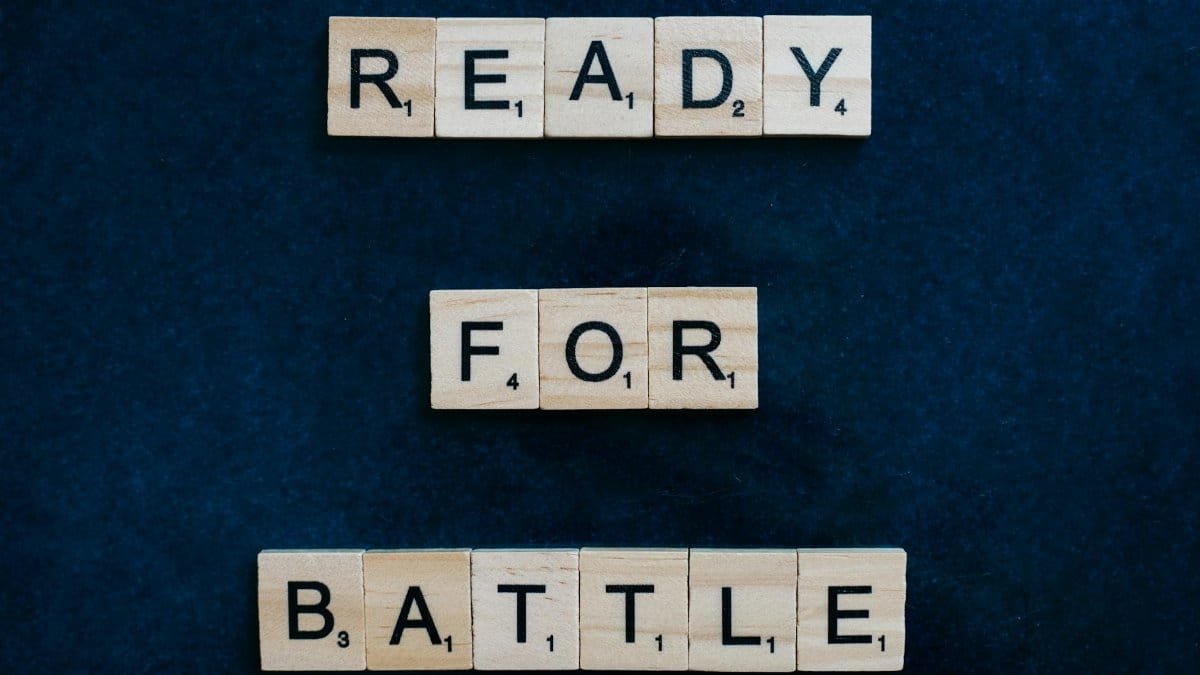 Scrabble tiles spell 'Ready for Battle' on a blue background, symbolizing motivation and readiness.