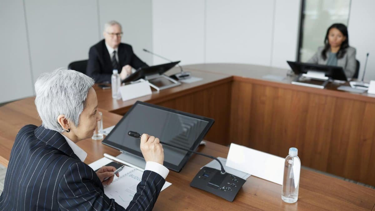 Senior executives discussing strategies in a modern boardroom setting.