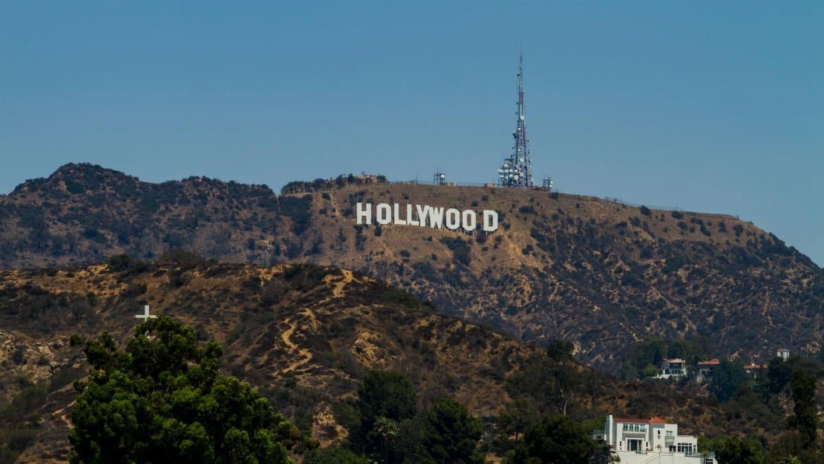 View of the iconic Hollywood Sign on Mount Lee with clear blue skies in Los Angeles, California.