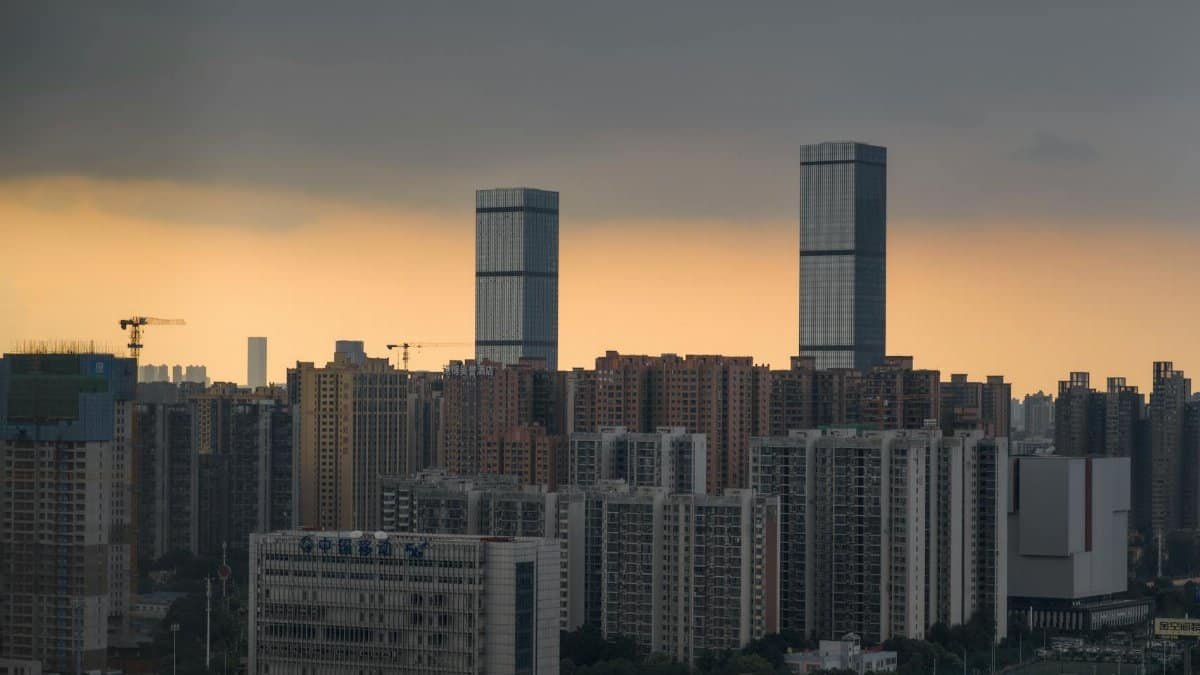 A dramatic cityscape with twin towers and a sunset sky, ideal for urban themes.