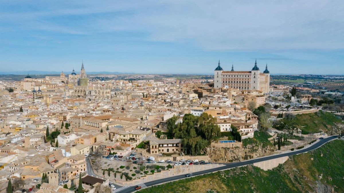 Stunning aerial view of Toledo, Spain featuring the Alcazar and historical architecture.
