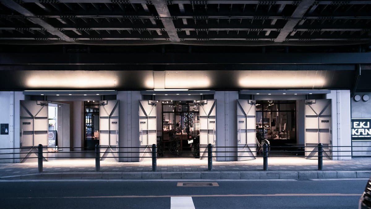 A stylish urban street scene at night with a modern lit building facade.