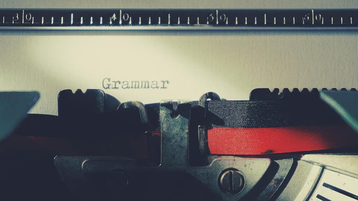 A detailed close-up of a vintage typewriter typing the word 'Grammar'.
