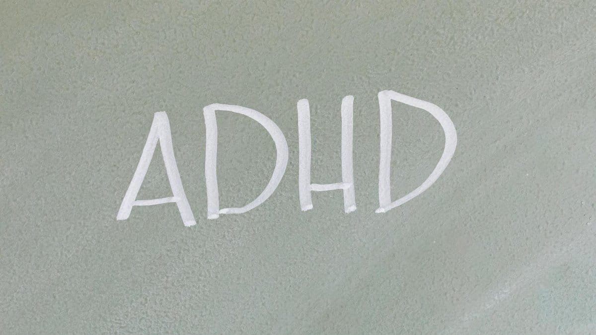 Close-up of the word ADHD on a textured surface, highlighting mental health awareness.