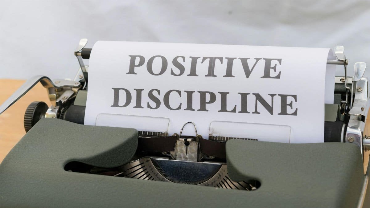Image of the words 'Positive Discipline' typed on a vintage typewriter, symbolizing constructive communication.