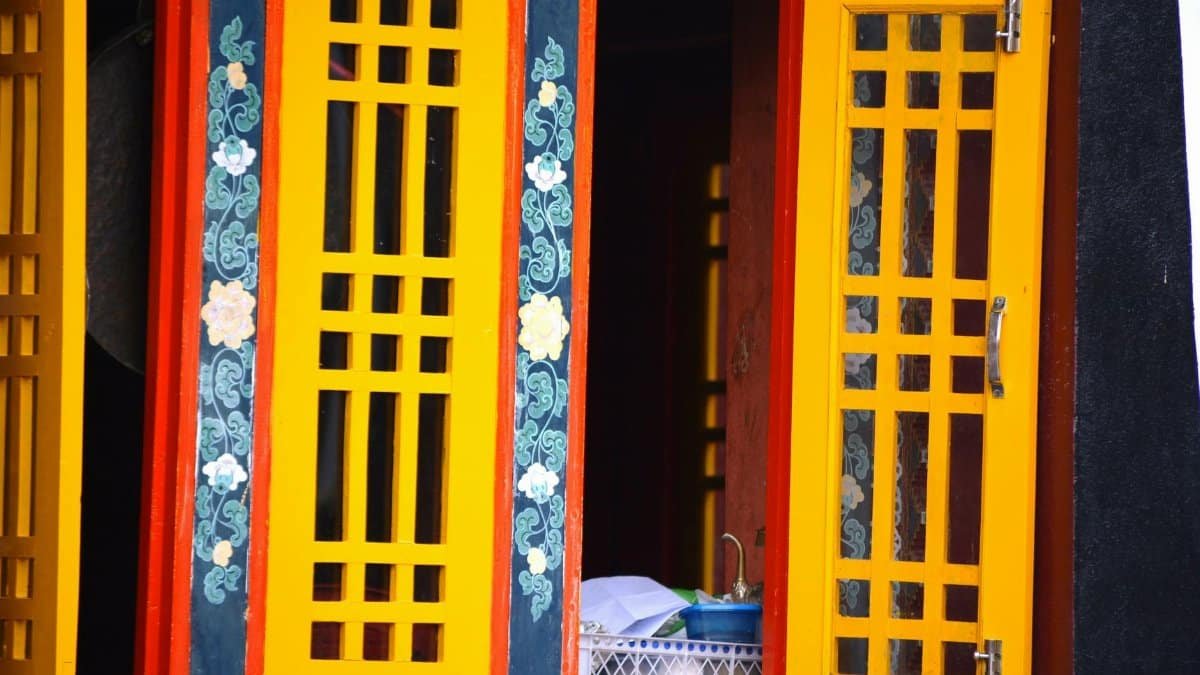 Colorful window with intricate patterns in a Gangtok monastery, Sikkim, India.