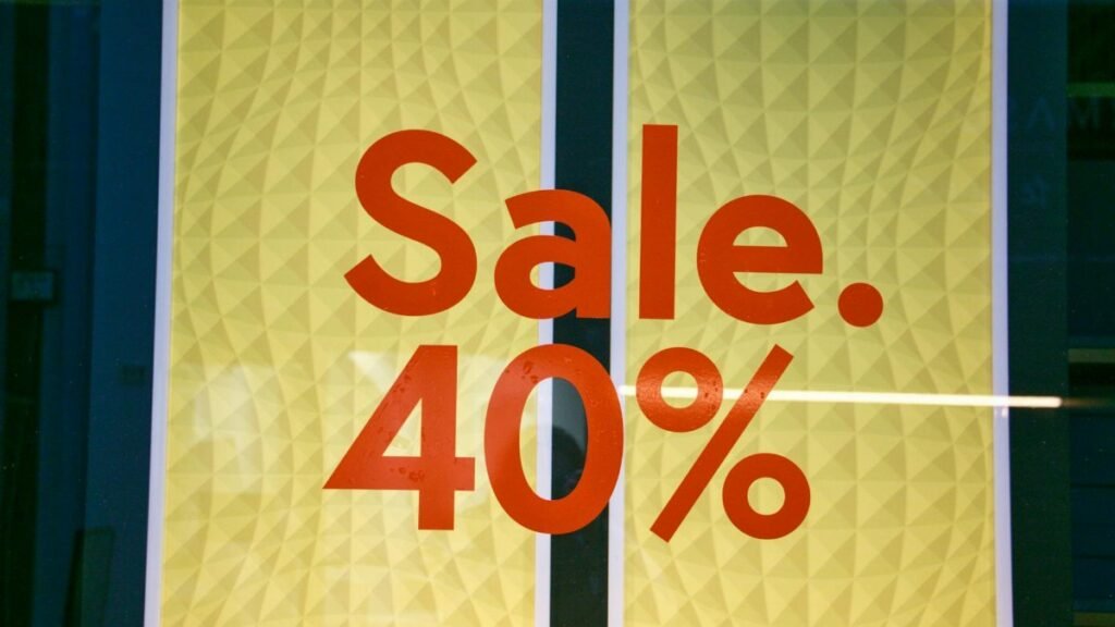 Bright retail sale sign showing 40 percent discount on yellow background.