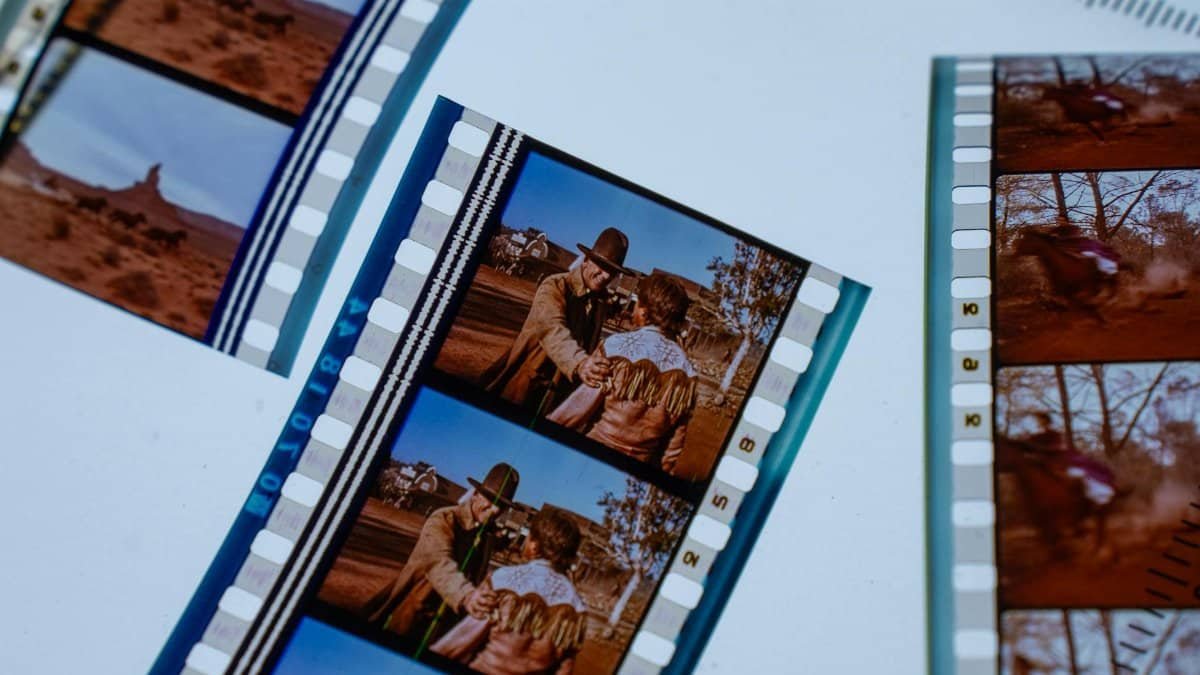Close-up of vintage movie filmstrips showcasing scenes of a classic Western film.