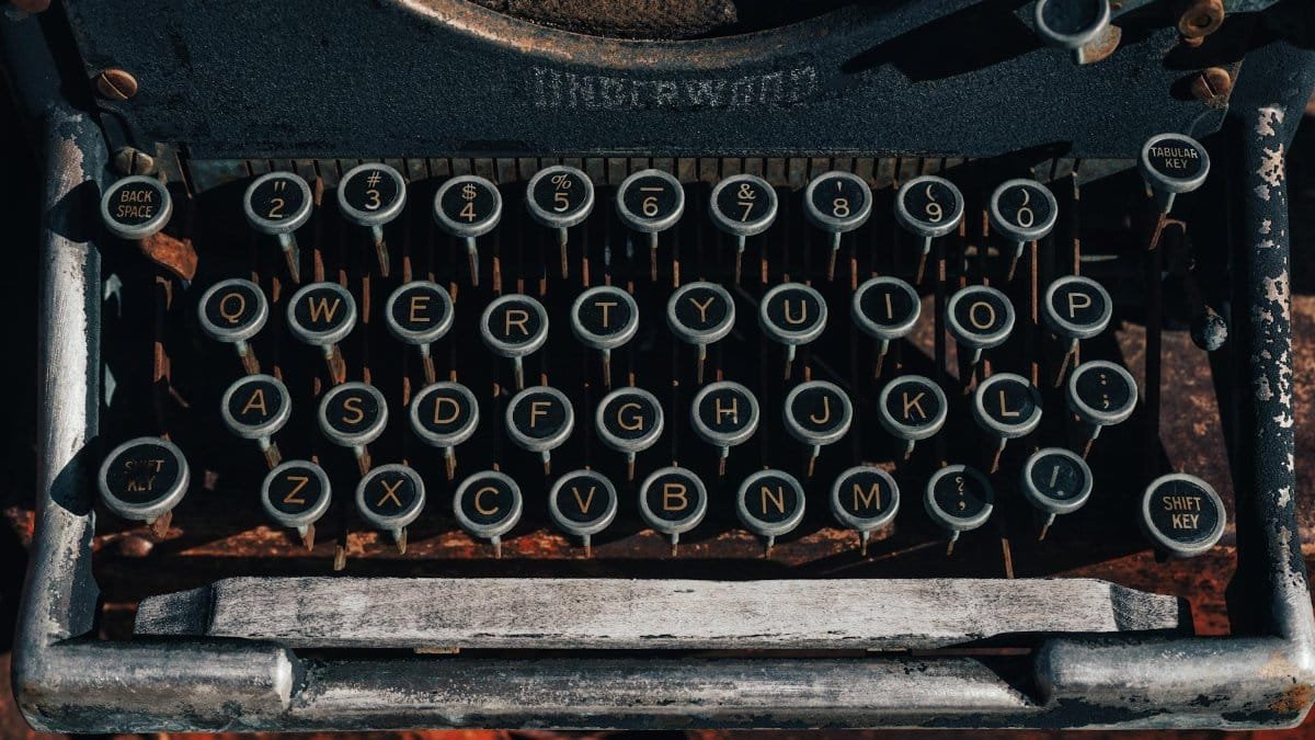Close-up of vintage typewriter keys with retro aesthetic and detailed buttons. Ideal for nostalgic themes.