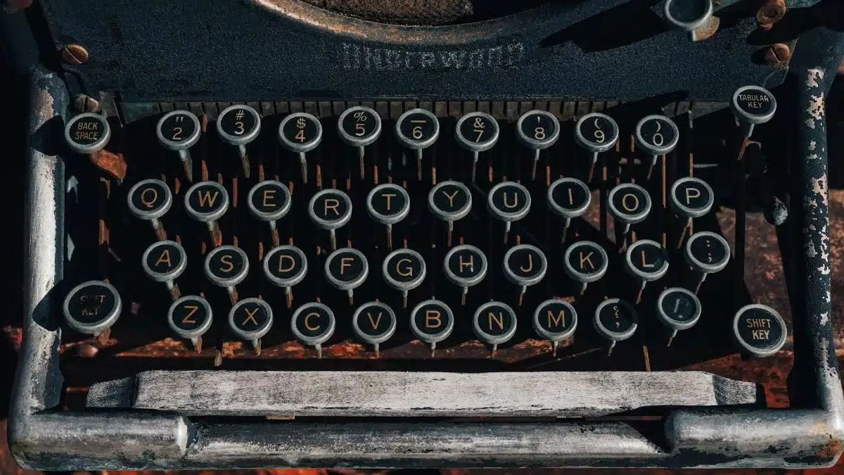 Close-up of vintage typewriter keys with retro aesthetic and detailed buttons. Ideal for nostalgic themes.