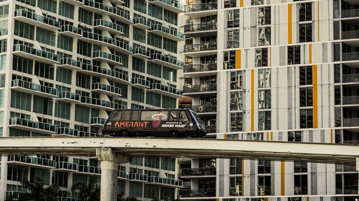 A Miami monorail travels past modern high-rise apartments in downtown Miami, Florida.