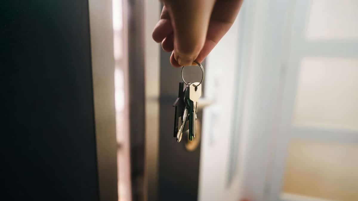 Close-up of a hand holding keys, symbolizing home ownership or rental entry.