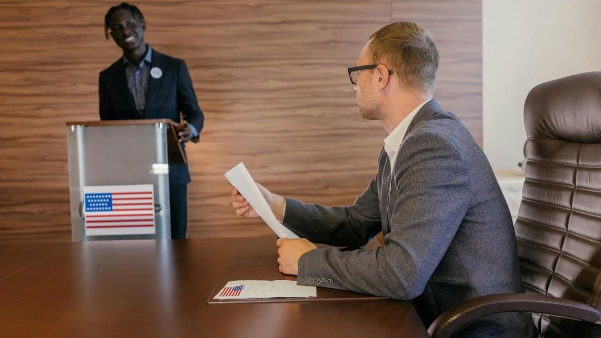 Two professionals in discussion during a political meeting in a modern conference room.