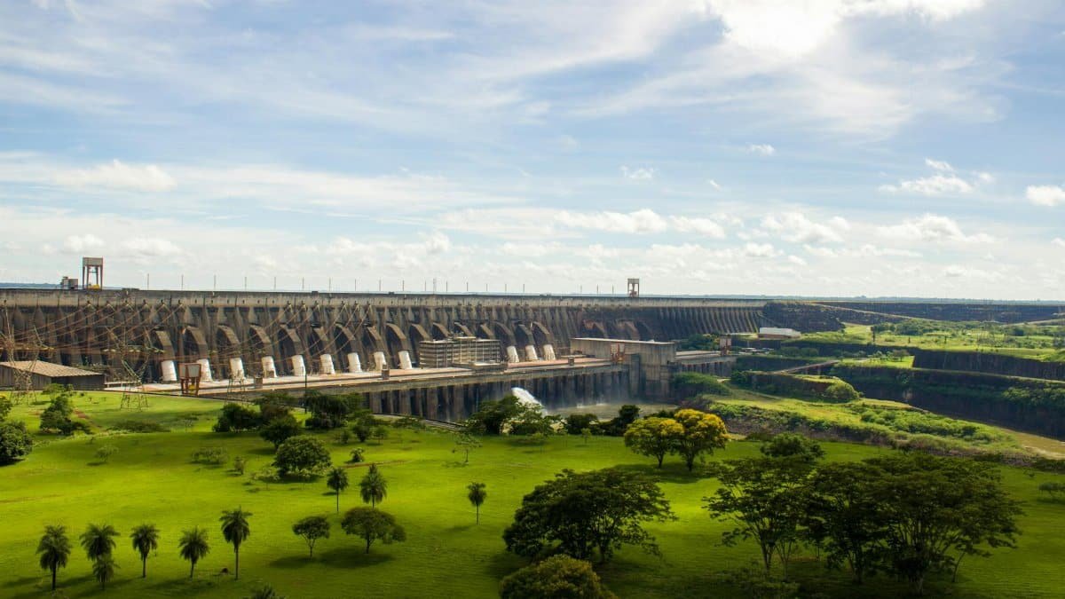 Experience the majestic Itaipu Dam surrounded by lush greenery in this scenic landscape view.