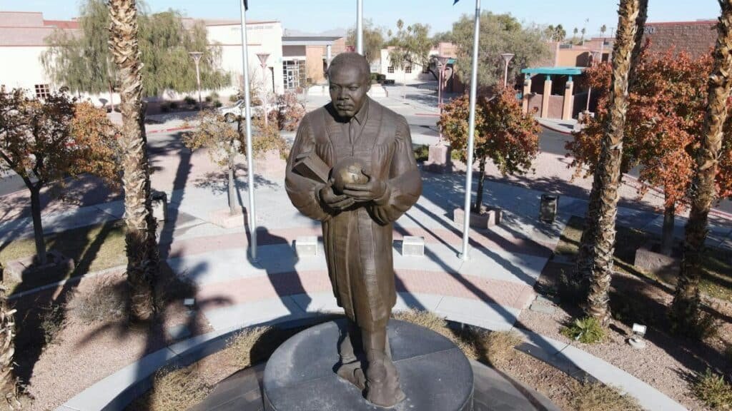 Bronze statue of Martin Luther King Jr. holding a globe in a Las Vegas park.