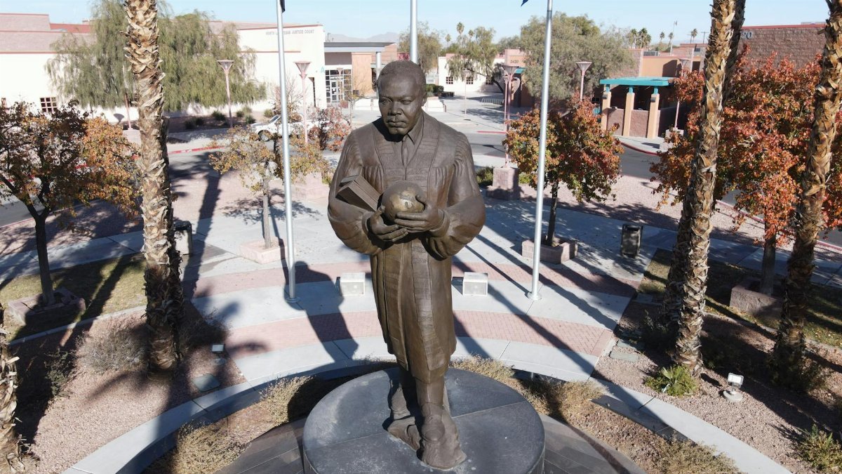 Bronze statue of Martin Luther King Jr. holding a globe in a Las Vegas park.