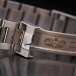 Close-up of a luxury silver watch bracelet showcasing intricate design details.