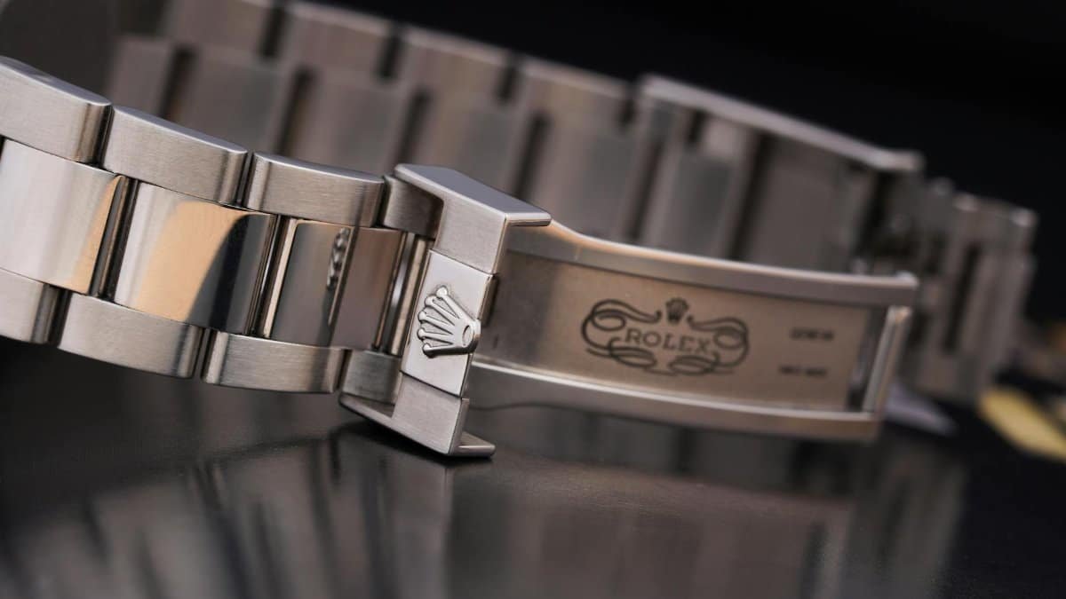 Close-up of a luxury silver watch bracelet showcasing intricate design details.