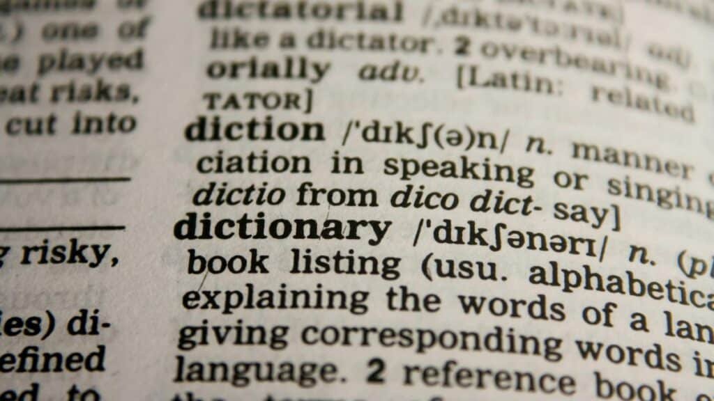 Detailed close-up view of a dictionary page highlighting the word 'dictionary' and its definition.