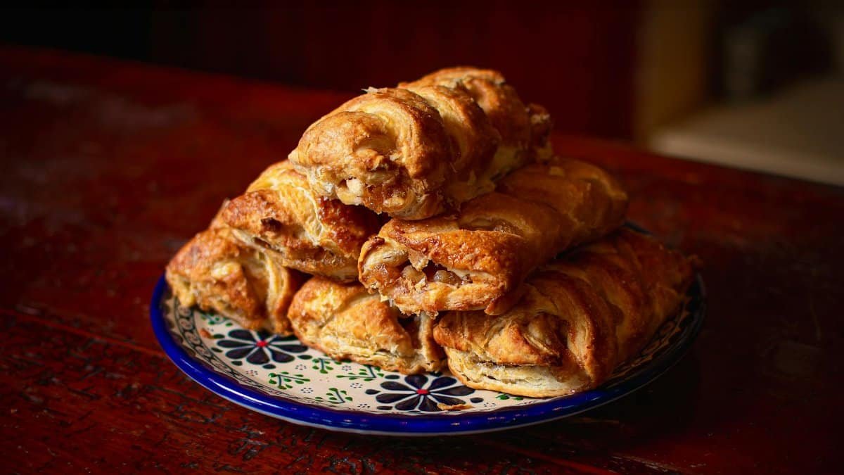 Captivating Mexican pastries served on a traditional Talavera plate, perfect for dessert lovers.