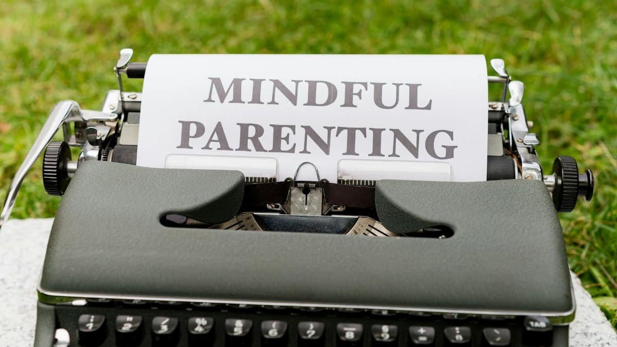 Close-up of a typewriter with 'Mindful Parenting' text, outdoors.
