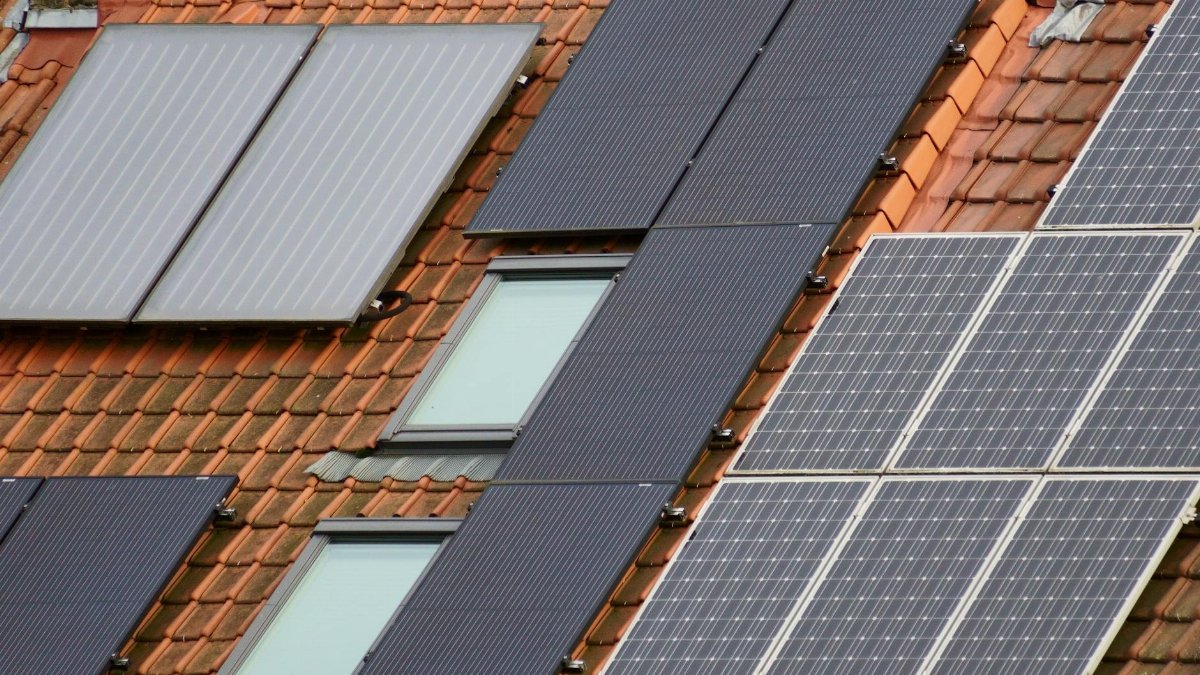 Close-up of solar panels on a tiled roof, showcasing sustainable energy solutions.