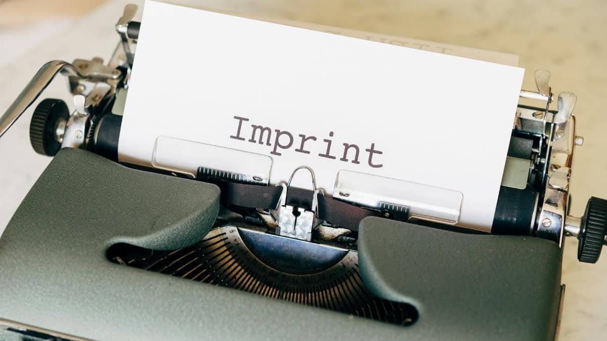 Close-up of a vintage typewriter with the word 'Imprint' on paper, evoking a classic retro feel.