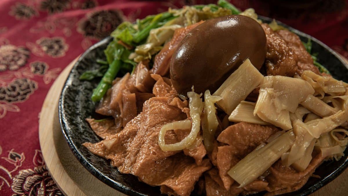 A savory dish featuring traditional Taiwanese street food with a marinated egg and vegetables, perfect for food enthusiasts.