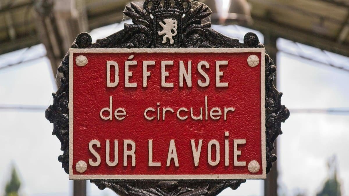 Close-up of a French railway warning sign at Thuin station, Belgium.