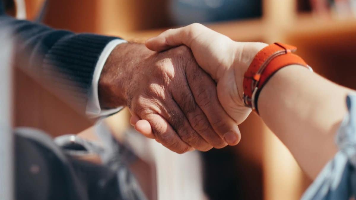 A close-up image of two people shaking hands, symbolizing a business agreement.