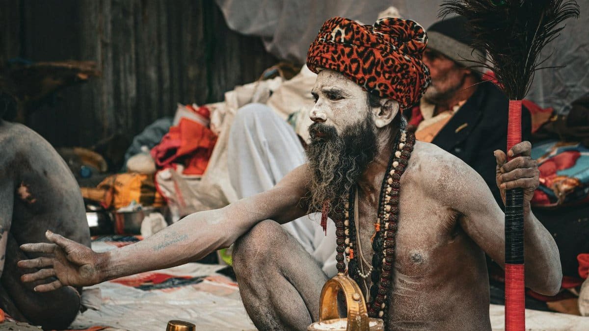 A man performing a traditional Hindu ritual outdoors, embodying cultural and religious heritage.