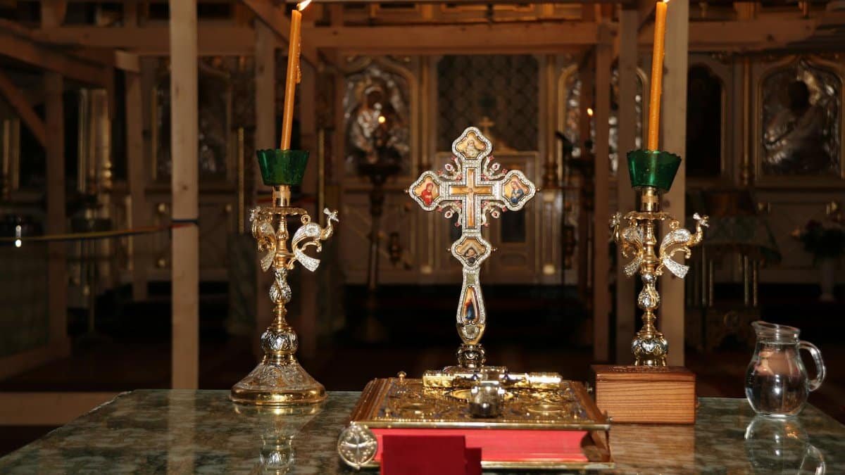 Intricately designed altar with crucifix and candles, capturing spiritual essence in a church setting.