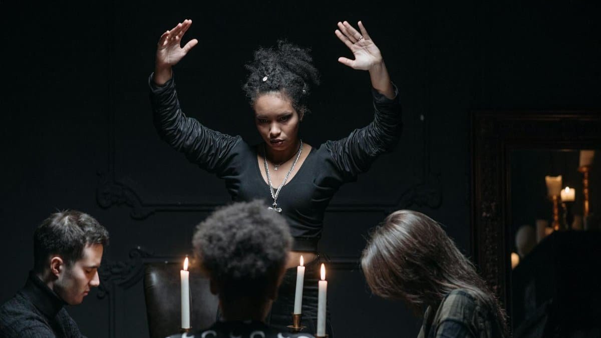 A spiritual seance gathering with participants around a candlelit table, engaging in mysticism.