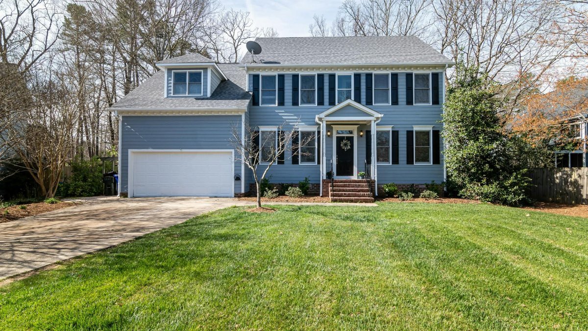 Bright suburban family home with spacious lawn and classic architecture.