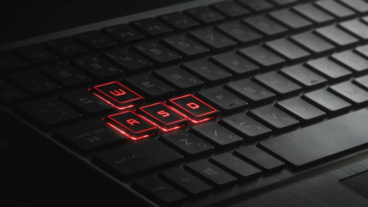 Close-up of illuminated WASD keys on a gaming keyboard with red LED lights.