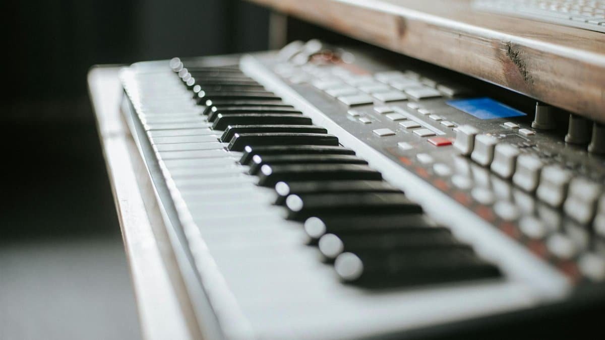 Detailed view of an electronic keyboard in a music production studio setting.