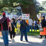 People gather at the Sacramento Capitol for a protest against tyranny, with signs advocating for freedom and immigration rights.