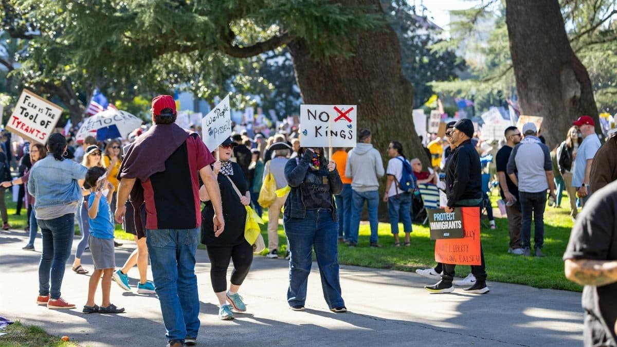 People gather at the Sacramento Capitol for a protest against tyranny, with signs advocating for freedom and immigration rights.
