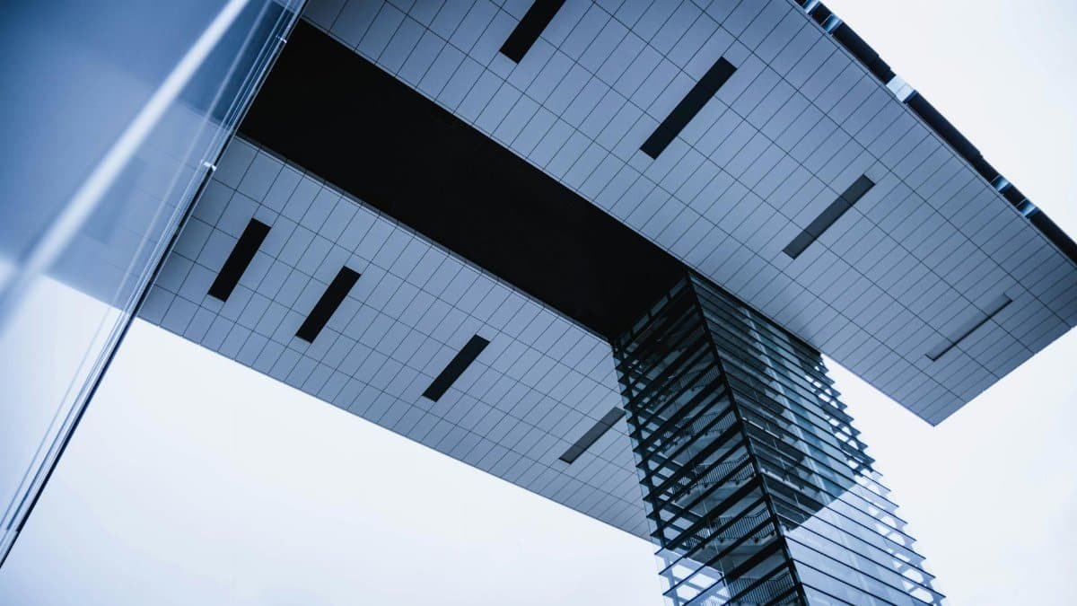 Low-angle architectural view of a modern building in Cologne, Germany, highlighting sleek exterior design.