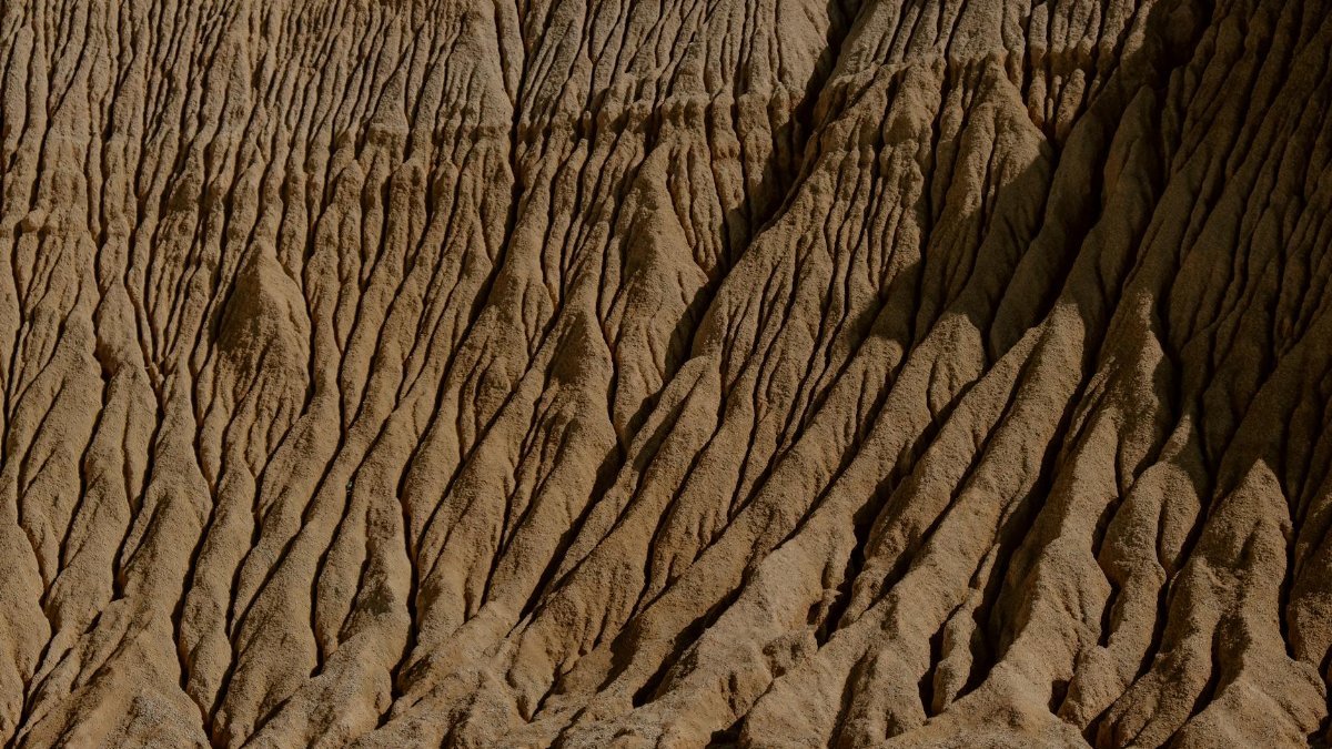 Close-up of weathered sandstone formations showcasing natural erosion patterns in an arid desert landscape.