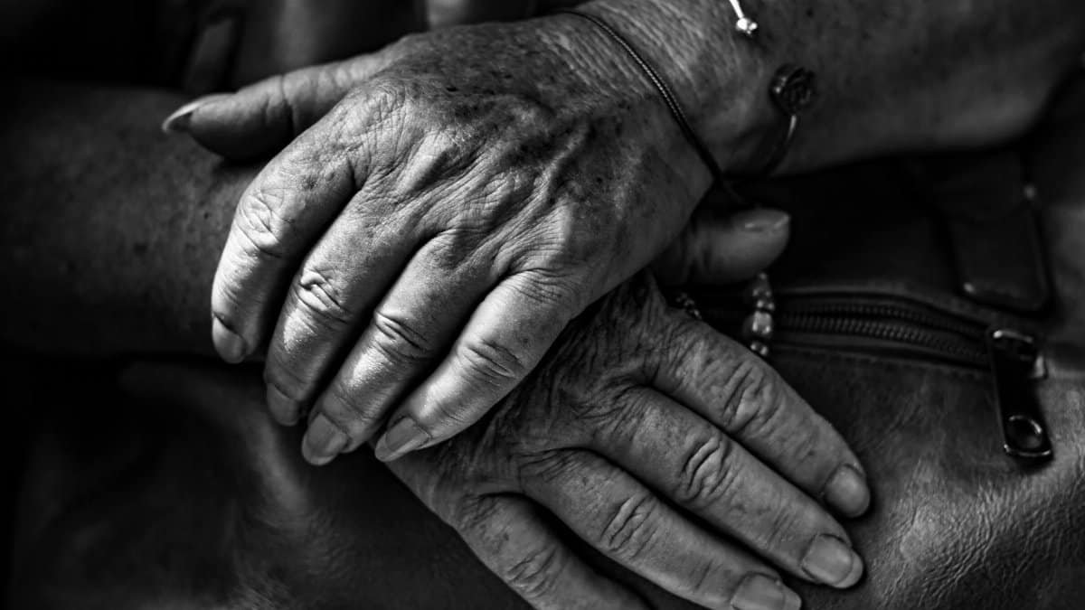 Detailed monochrome image of elderly hands showing age and experience.