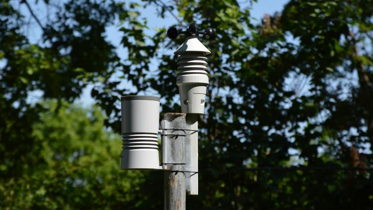Close-up of an anemometer and weather device on a sunny day outdoors.