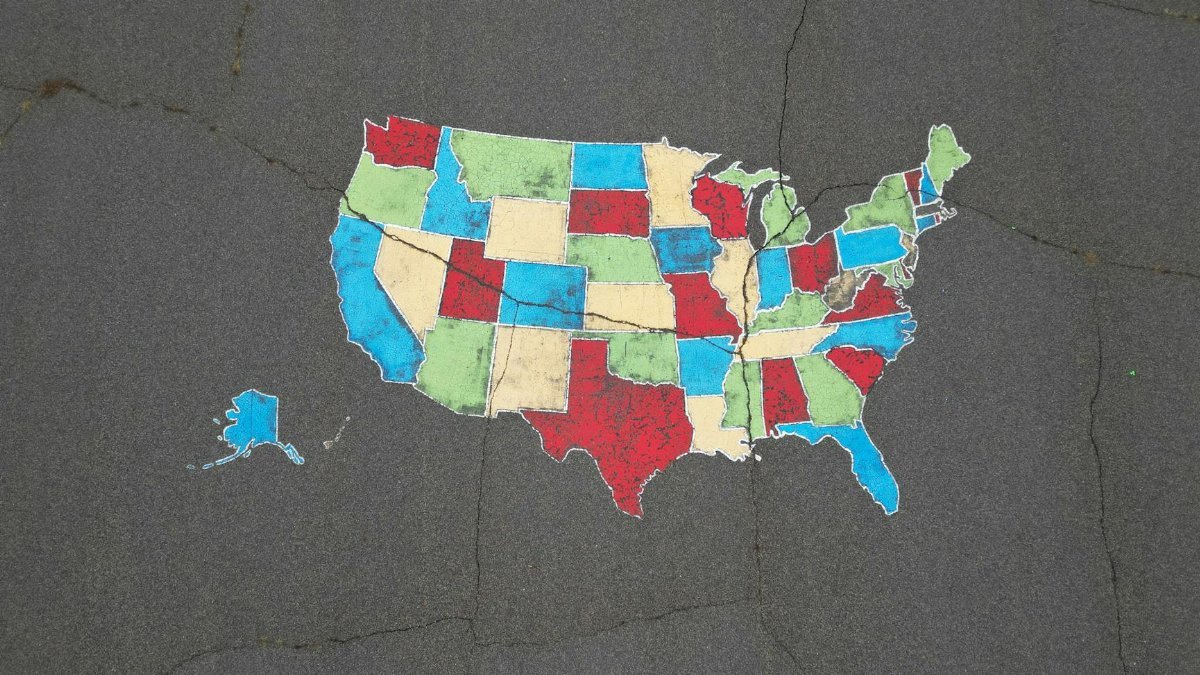 Vibrant map of the USA painted on pavement, showcasing bold state colors.