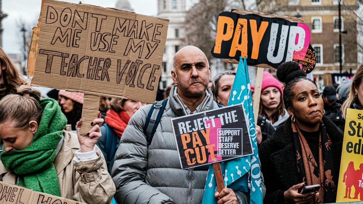 Teachers join a protest in London demanding fair pay and better conditions.
