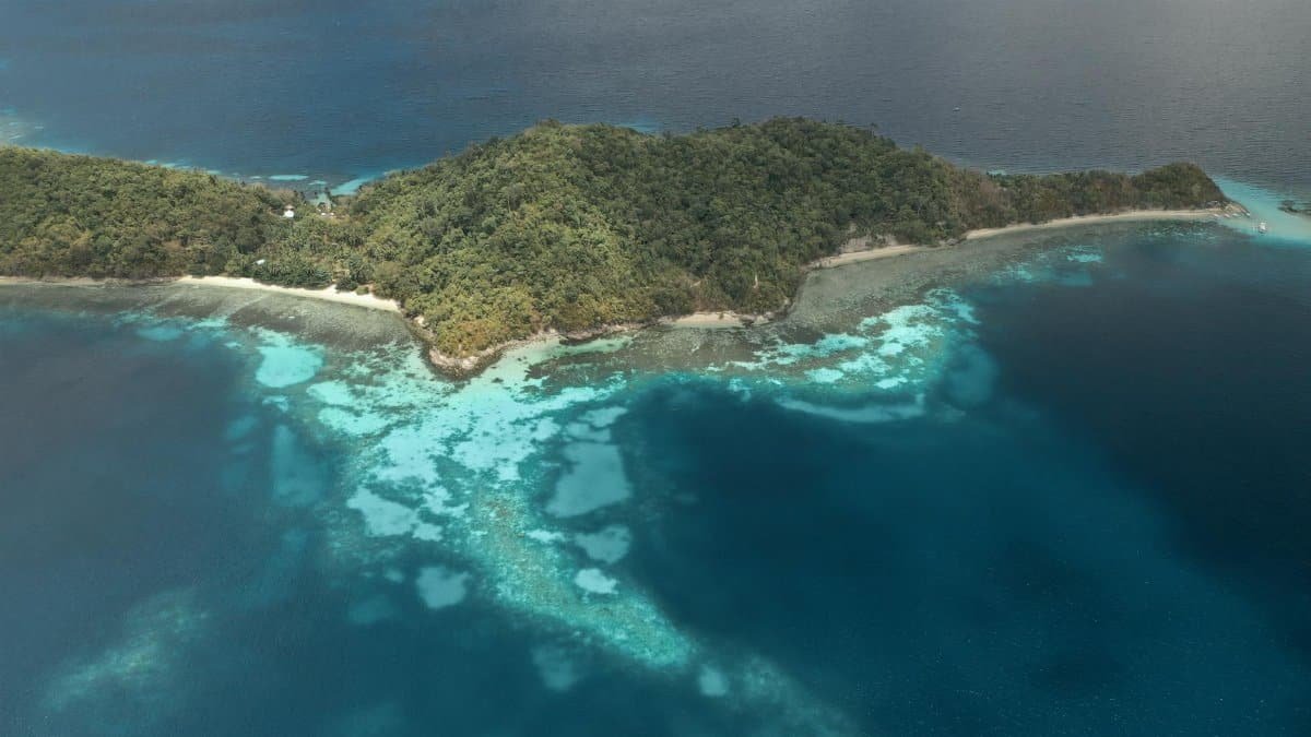 A stunning aerial view of a tropical island surrounded by the vibrant Sulu Sea in the Philippines.