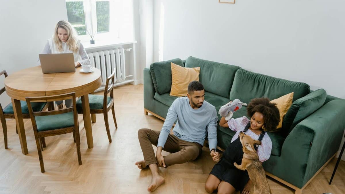 A family enjoying quality time with their dog in a contemporary living room setting.