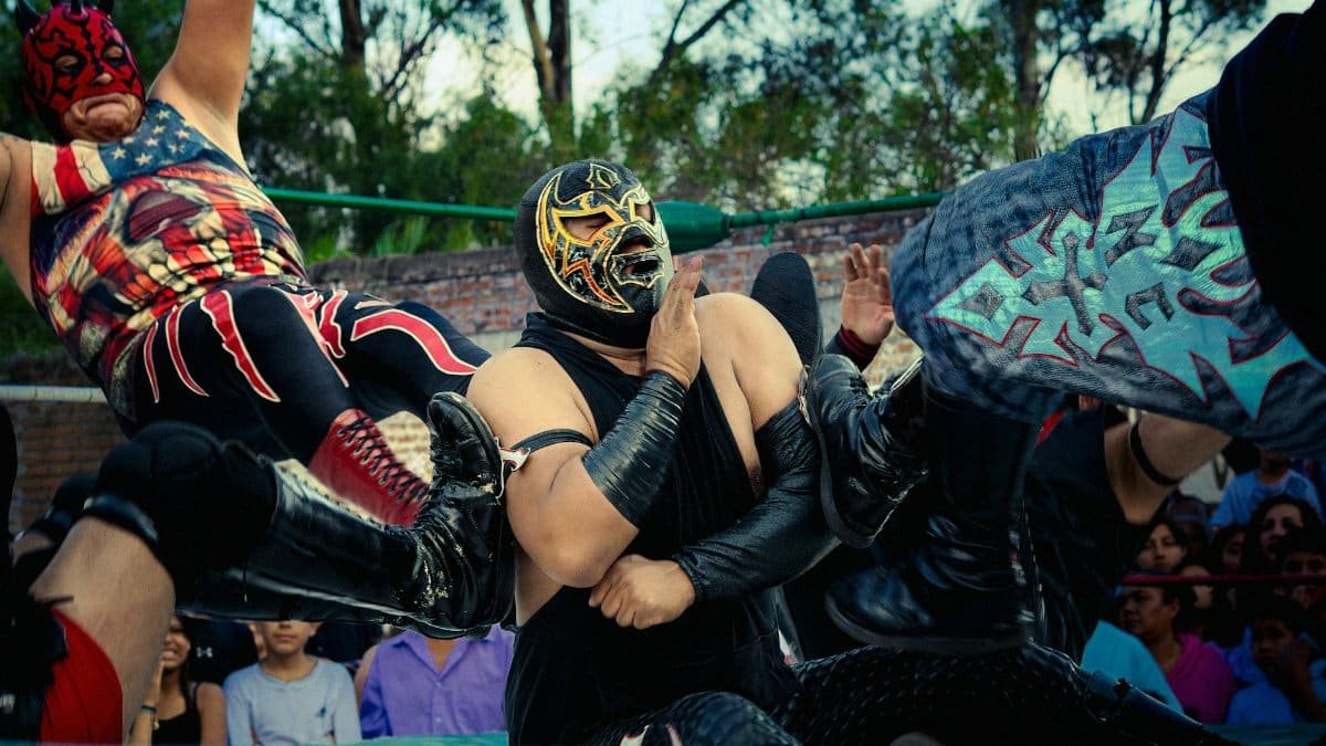 Dramatic lucha libre scene with masked wrestlers in the ring, showcasing dynamic action.