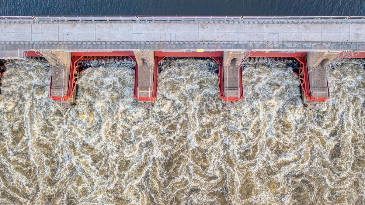 Aerial shot of the turbulent water flow at a dam in Alma, Wisconsin, showcasing engineering and nature.